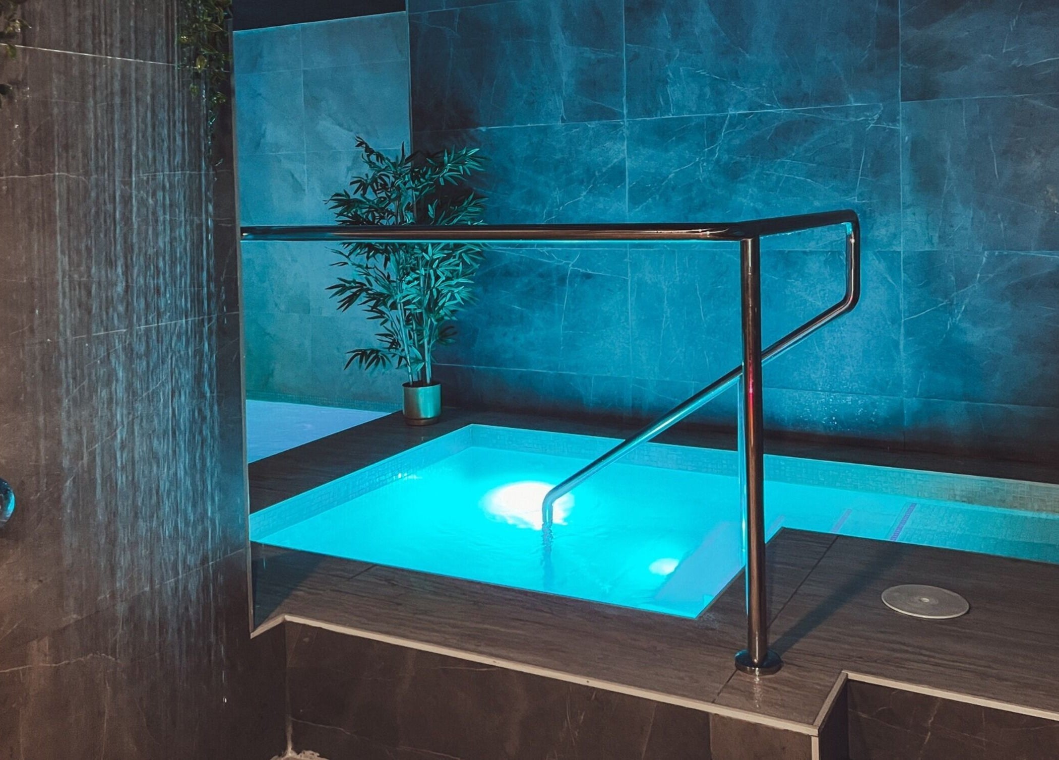 Relaxing illuminated pool at E1 Spa and Wellness in Gibraltar, GI offering a serene wellness experience.