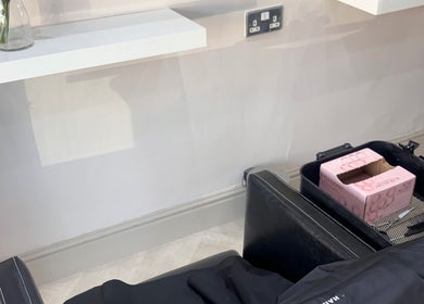 Salon station at Cc Styled It, Birmingham, England, GB with a sleek black chair and shelf.