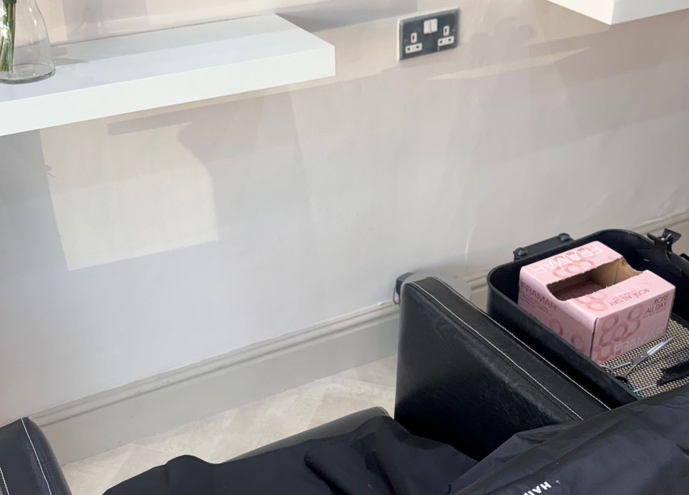 Salon station at Cc Styled It, Birmingham, England, GB with a sleek black chair and shelf.