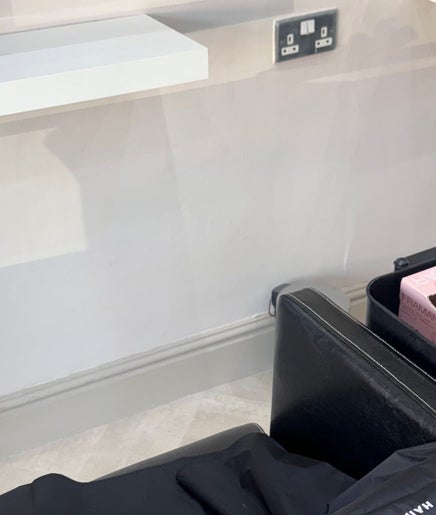 Salon station at Cc Styled It, Birmingham, England, GB with a sleek black chair and shelf.