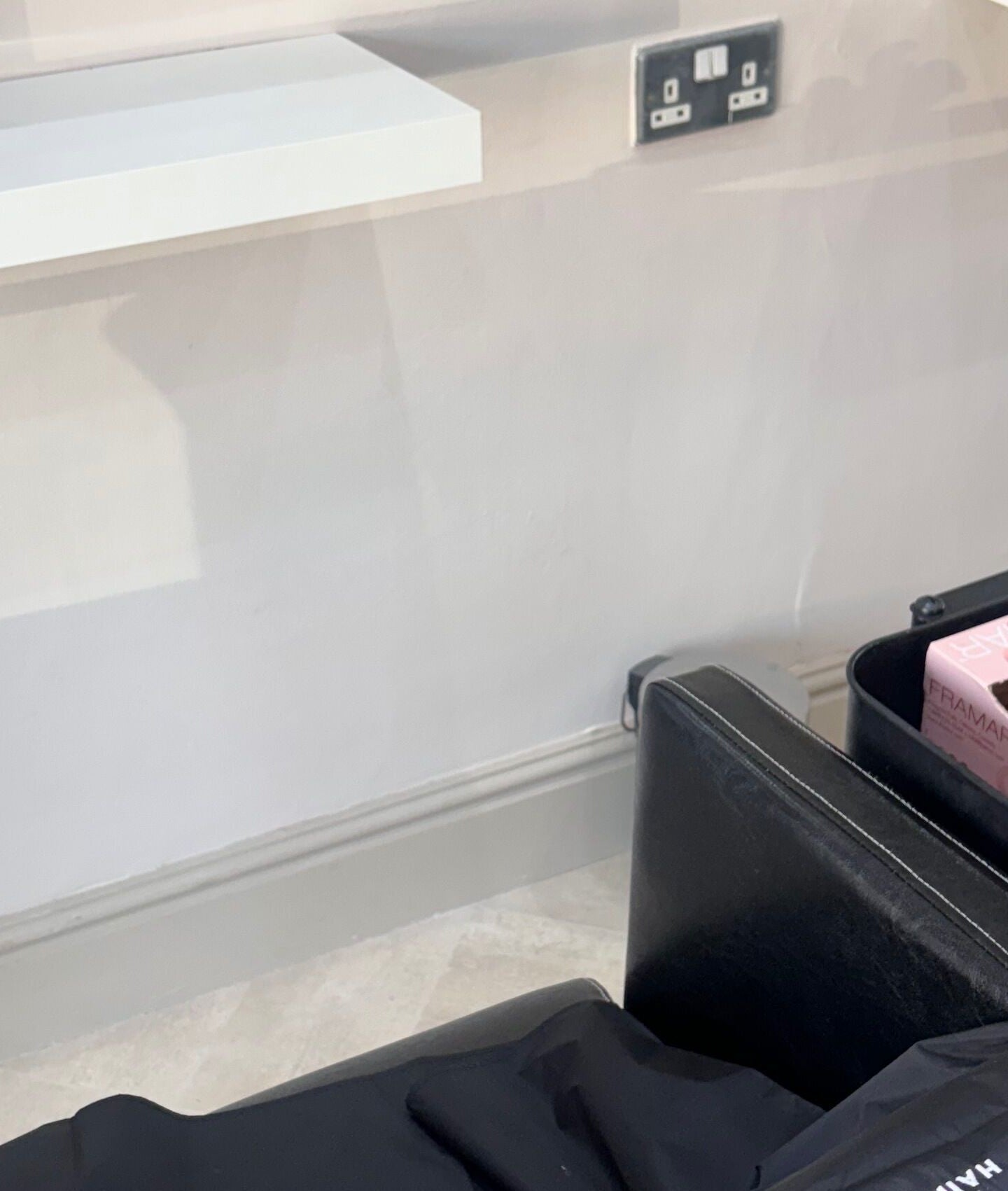 Salon station at Cc Styled It, Birmingham, England, GB with a sleek black chair and shelf.