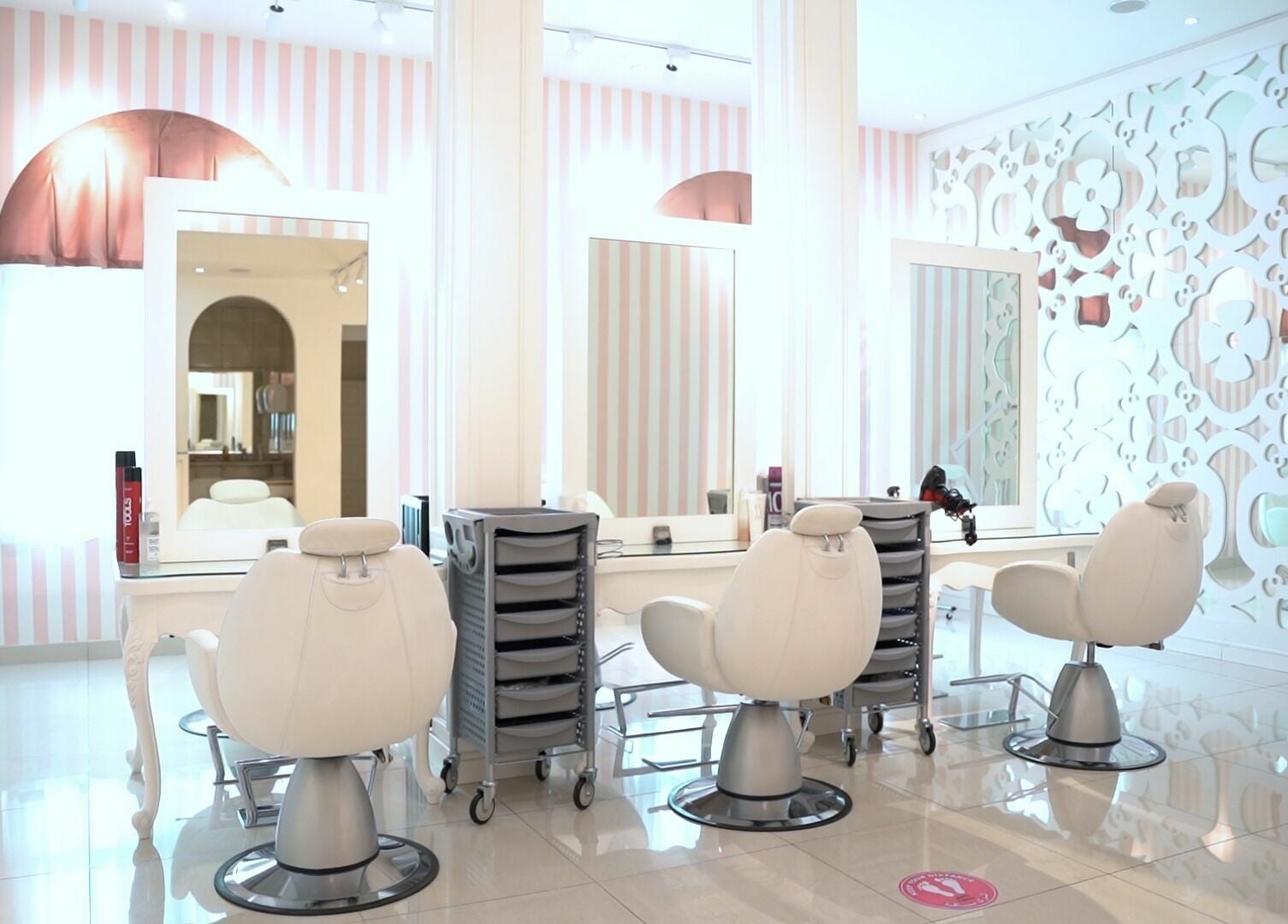 Modern styling chairs in Shatha Beauty Centre, Sharjah, AE, with elegant decor and mirrors.