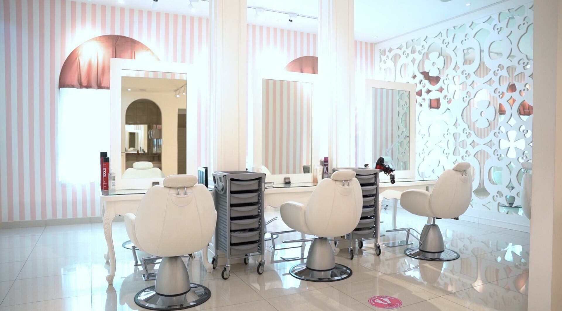 Modern styling chairs in Shatha Beauty Centre, Sharjah, AE, with elegant decor and mirrors.