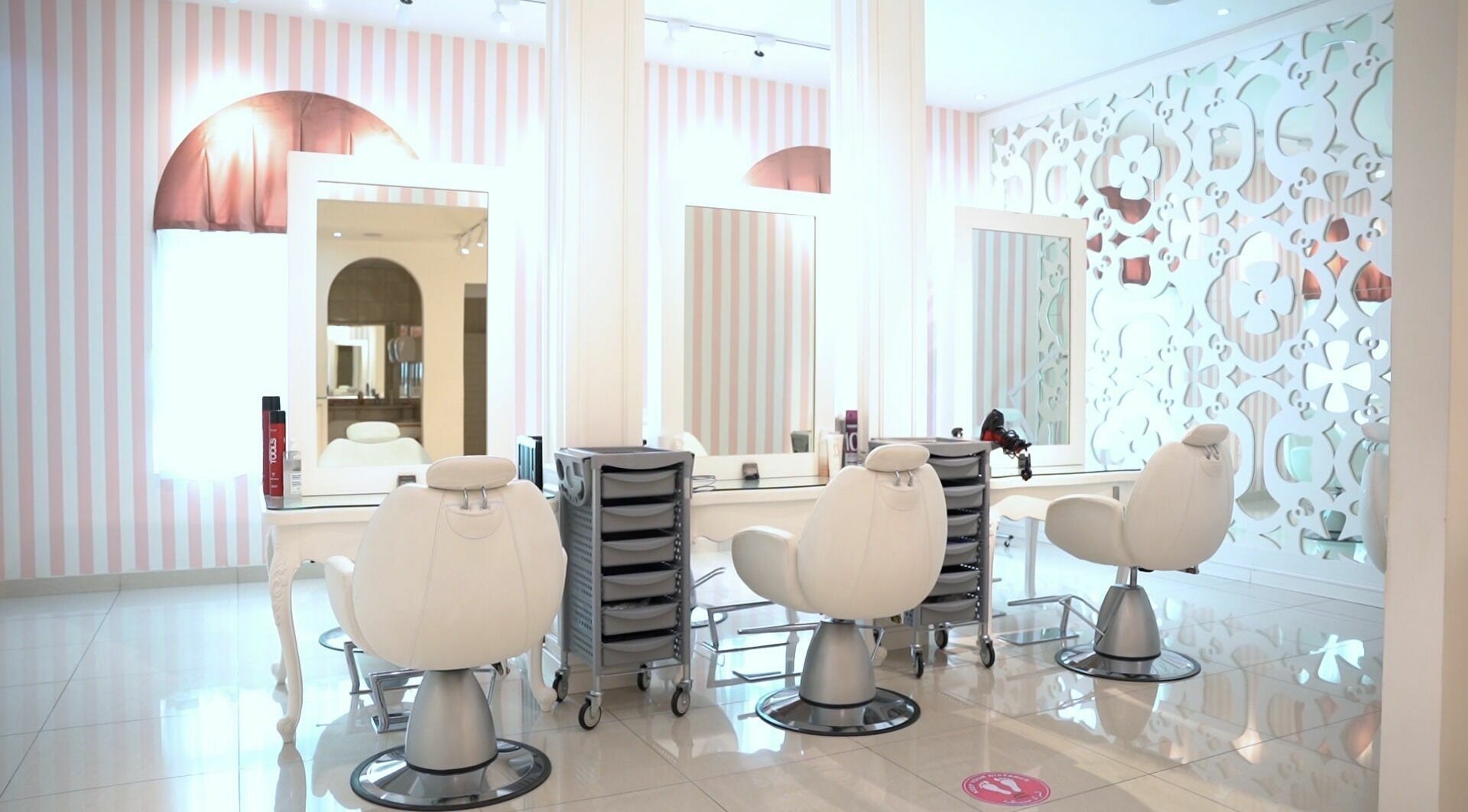 Modern styling chairs in Shatha Beauty Centre, Sharjah, AE, with elegant decor and mirrors.