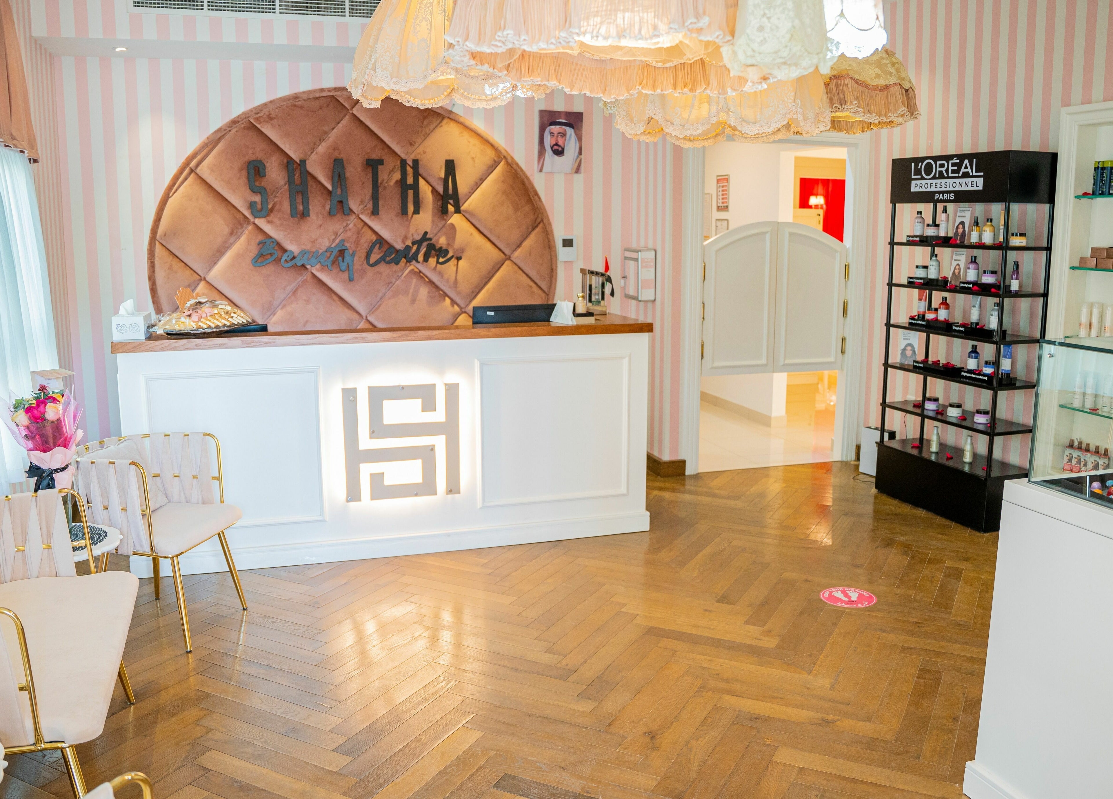 Chic reception area at Shatha Beauty Centre in Sharjah, AE, featuring stylish decor and product displays.