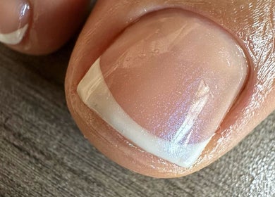 Stylish French manicure on toes at Tat's Nails Scottsdale, Scottsdale, Arizona, US.