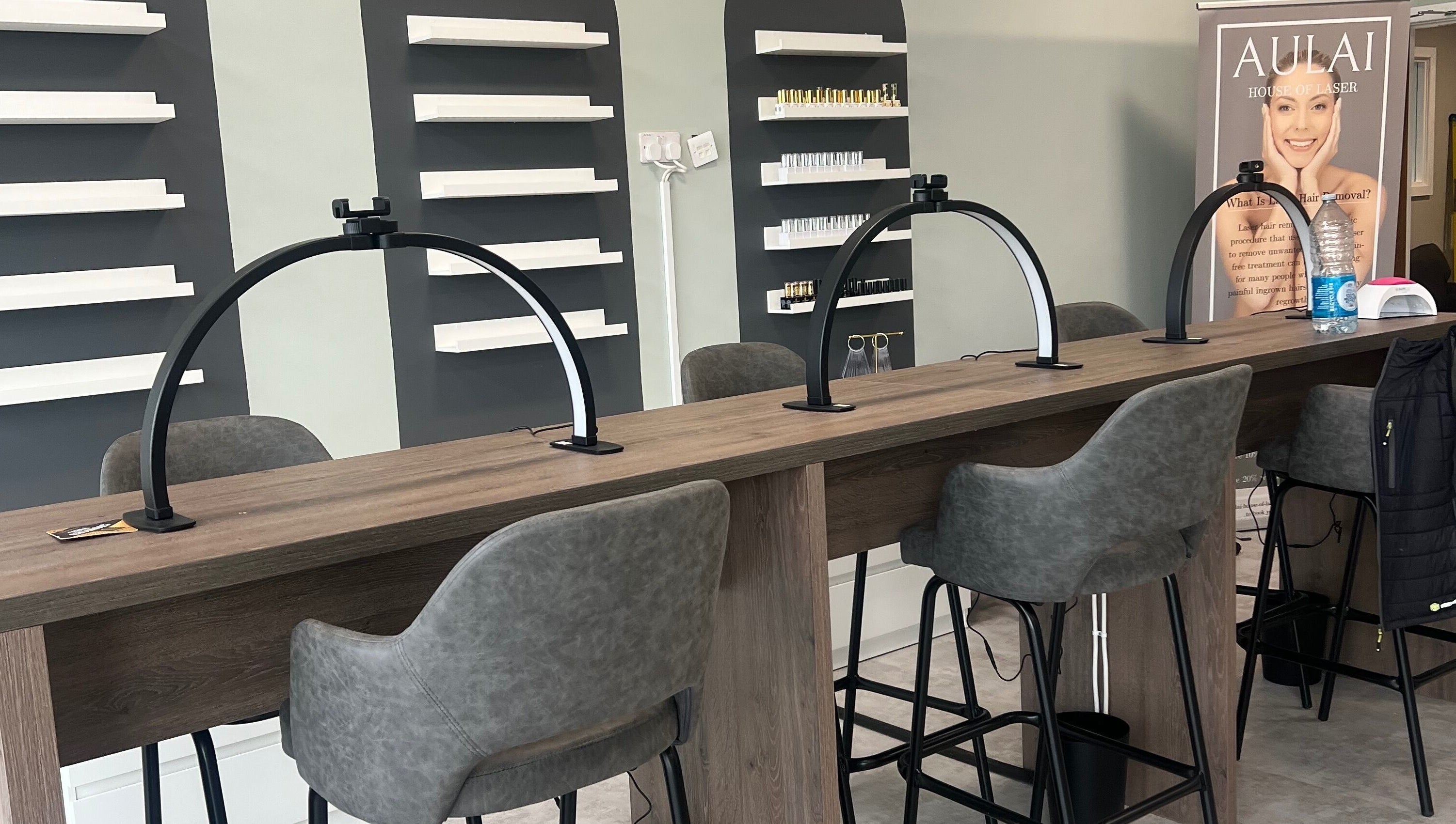 Modern nail station at Filled Aesthetics, Cannock, England, GB with sleek chairs and elegant shelving.