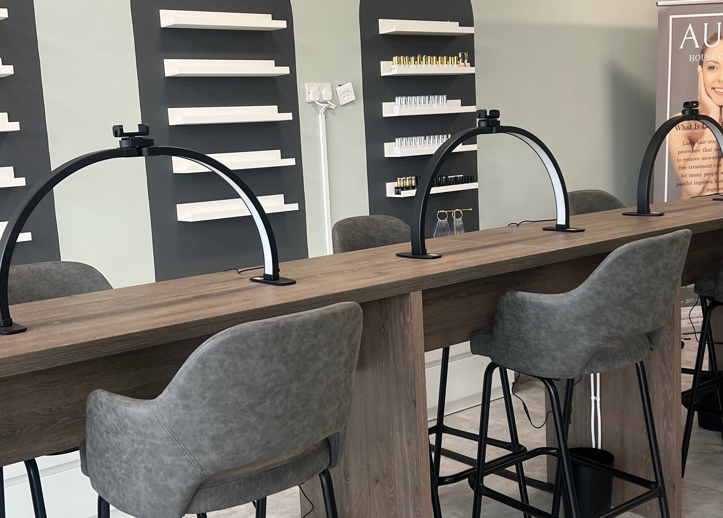 Modern nail station at Filled Aesthetics, Cannock, England, GB with sleek chairs and elegant shelving.
