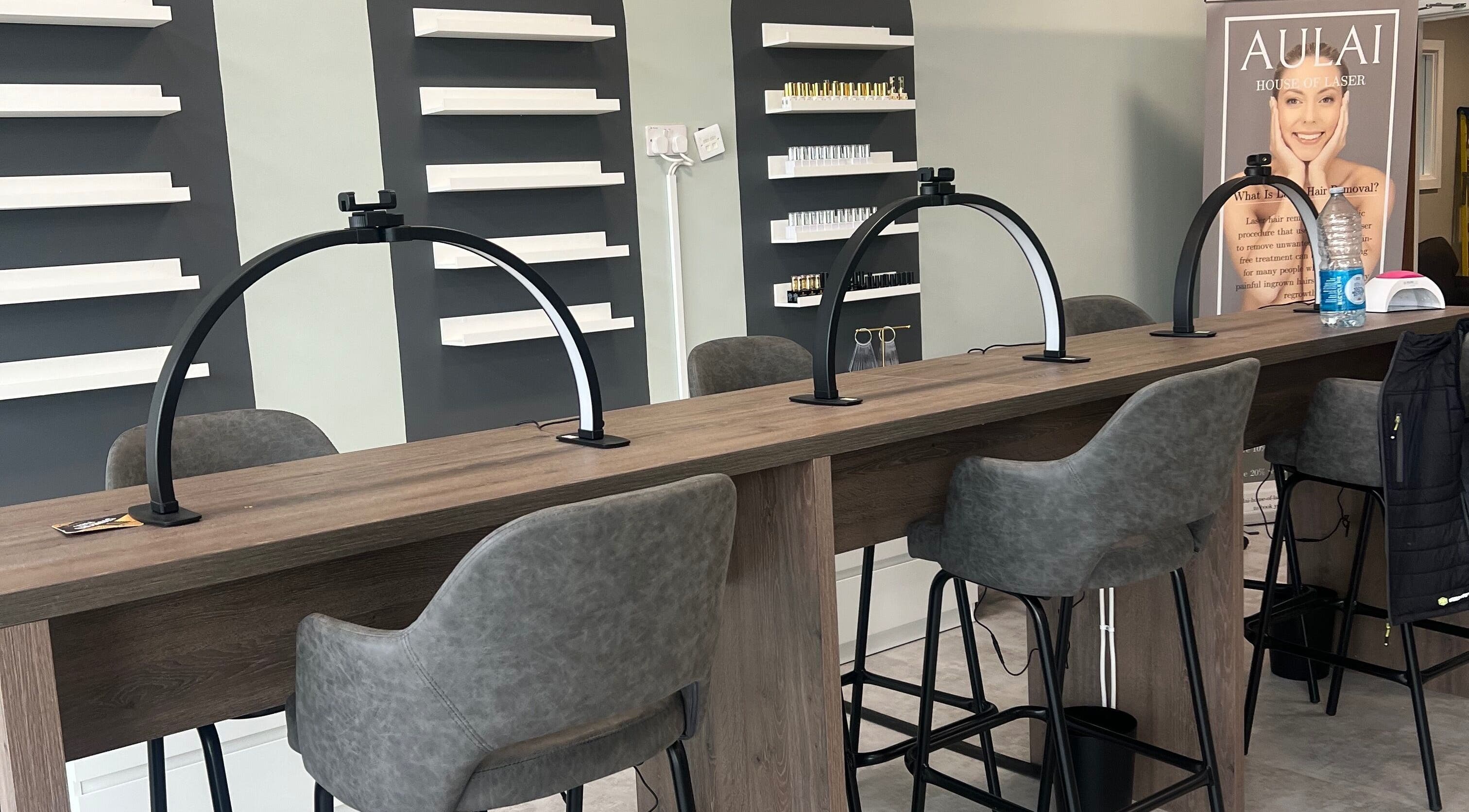 Modern nail station at Filled Aesthetics, Cannock, England, GB with sleek chairs and elegant shelving.
