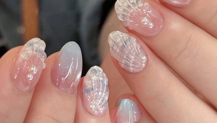 Intricate seashell nail art at Happy Nail South Yarra in Melbourne, Victoria, AU, showcasing delicate marine designs.