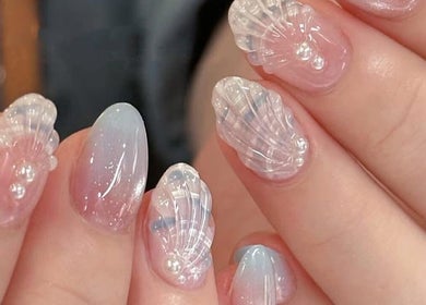 Intricate seashell nail art at Happy Nail South Yarra in Melbourne, Victoria, AU, showcasing delicate marine designs.