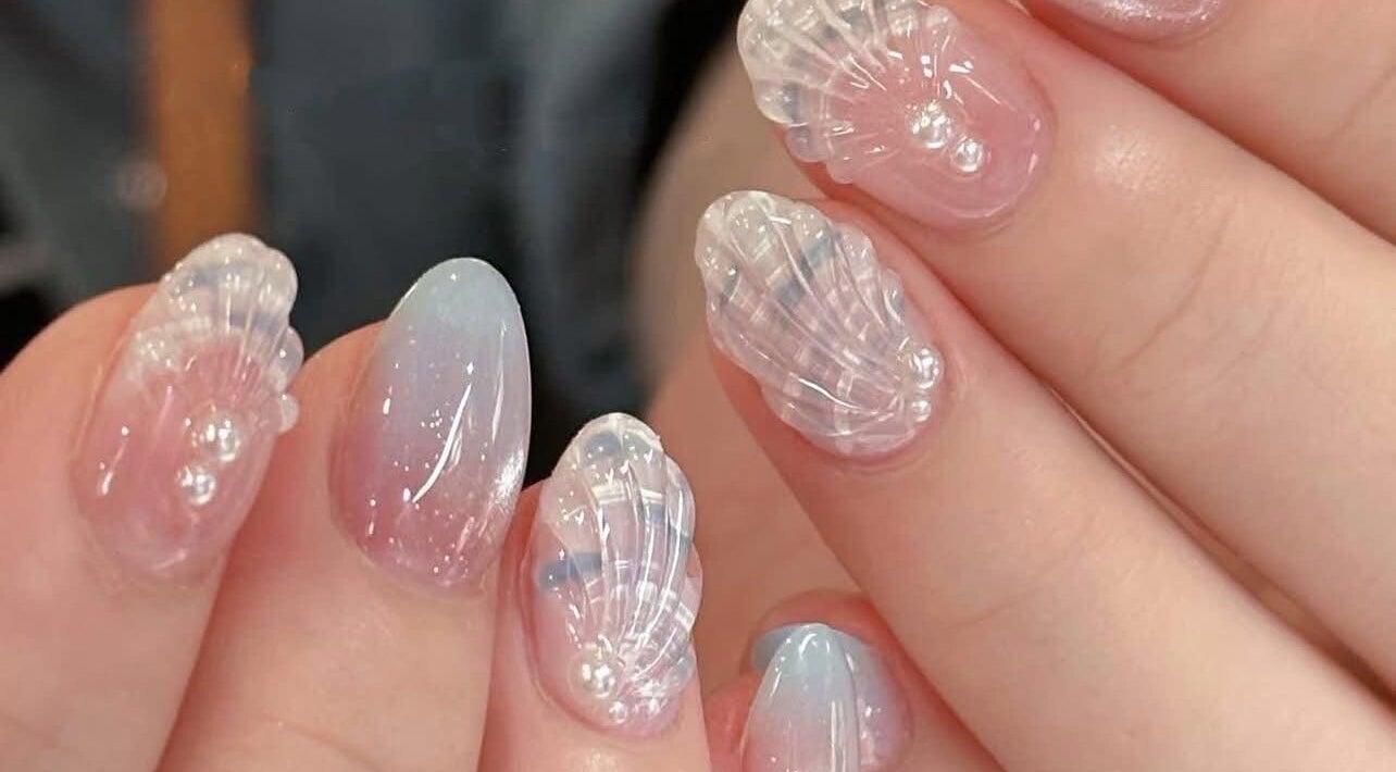 Intricate seashell nail art at Happy Nail South Yarra in Melbourne, Victoria, AU, showcasing delicate marine designs.