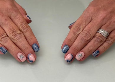 Stylish nail art with star accents at Melodysnailbiz in Aylesford, England, GB.