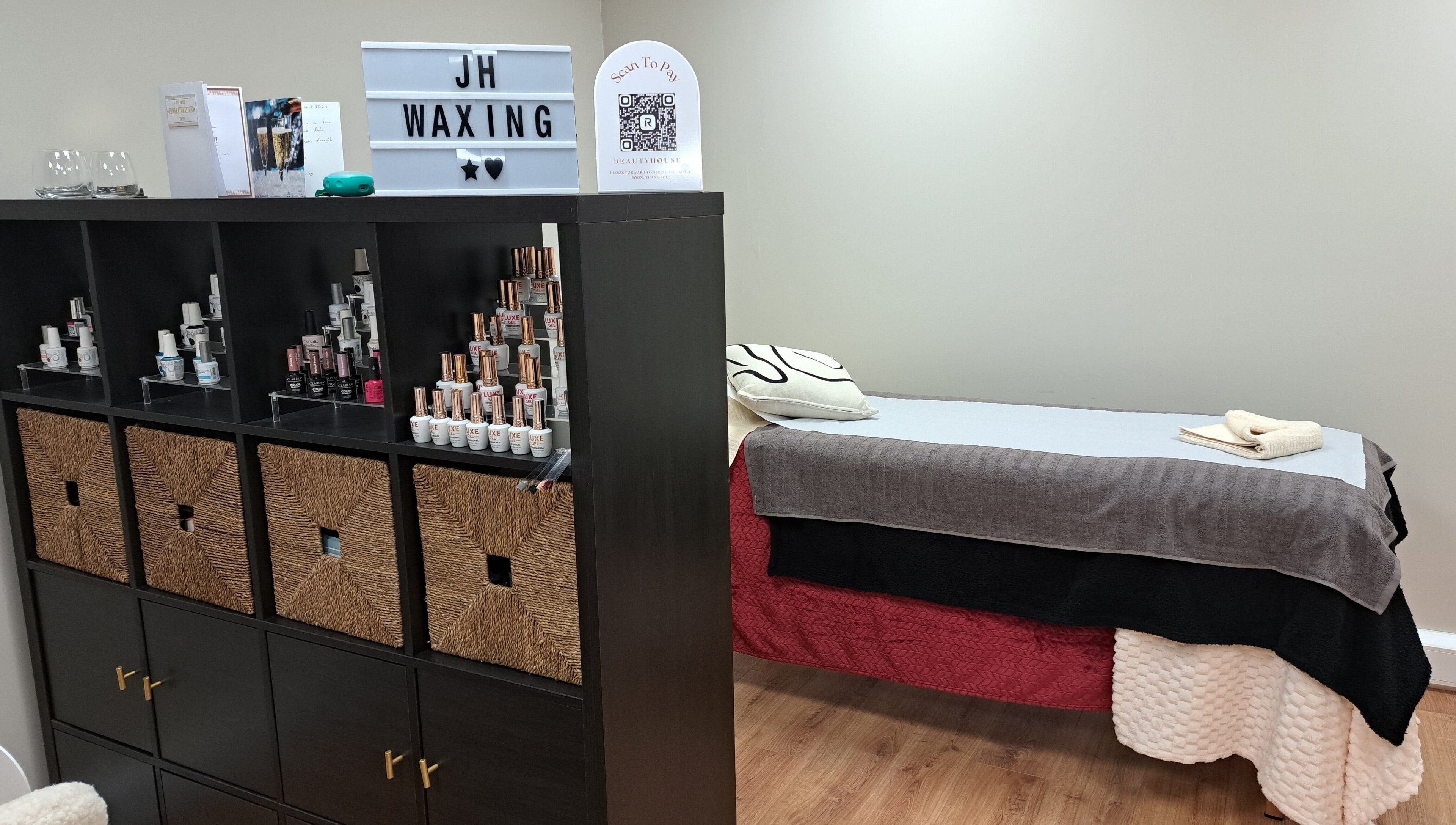 Elegant waxing room at JH Specialised Waxing, Carrickmines, County Dublin, IE with treatment bed and product display.