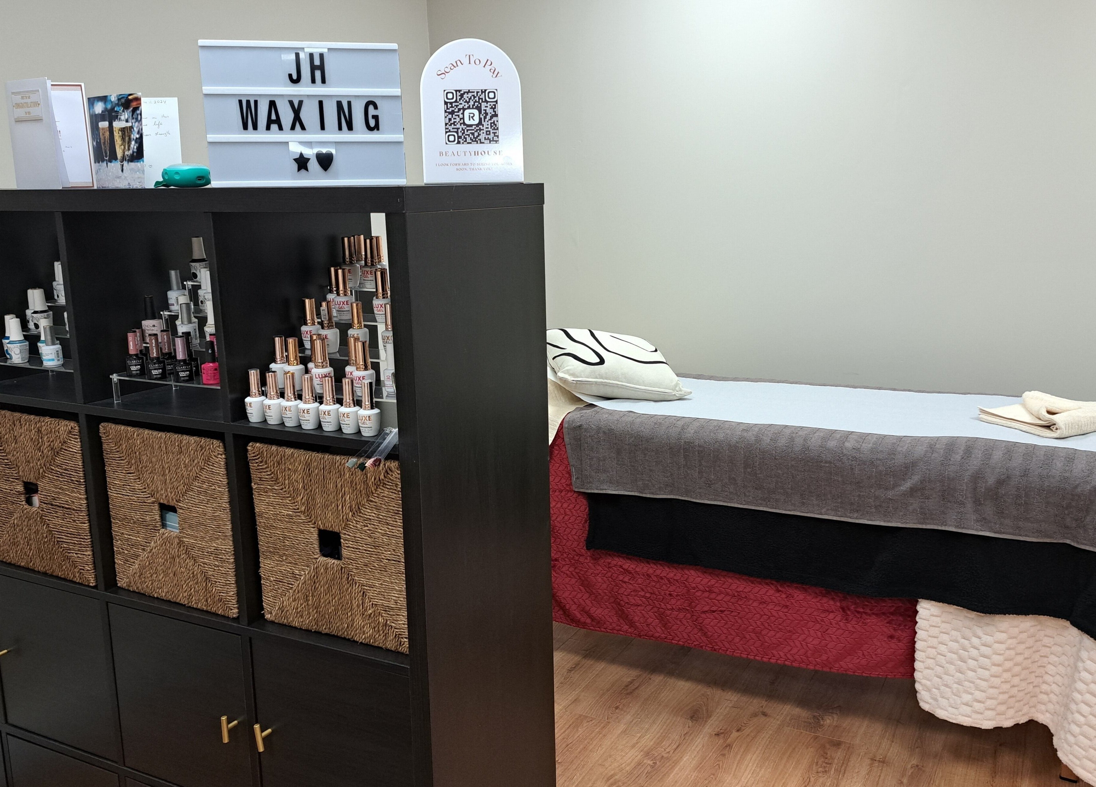 Elegant waxing room at JH Specialised Waxing, Carrickmines, County Dublin, IE with treatment bed and product display.
