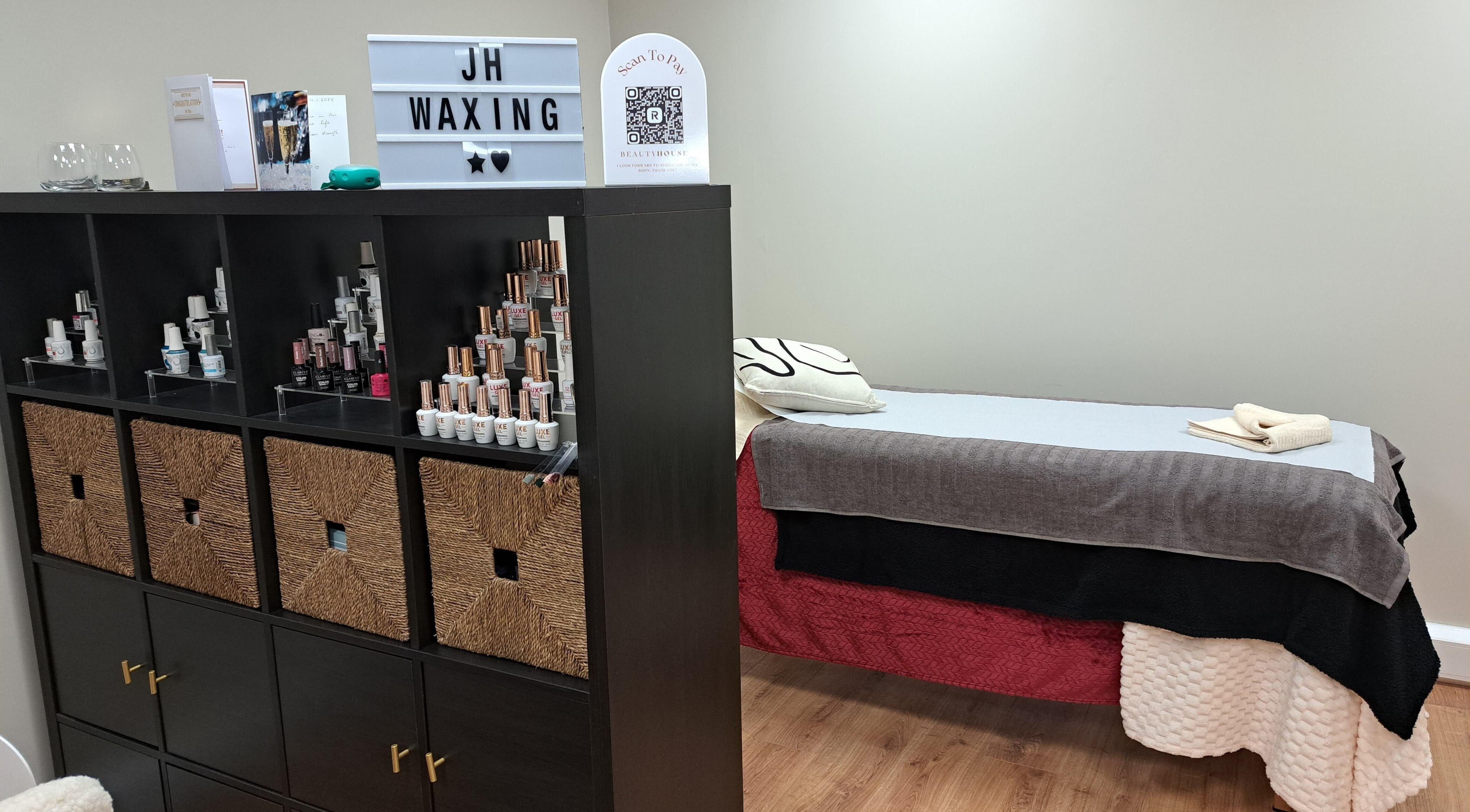 Elegant waxing room at JH Specialised Waxing, Carrickmines, County Dublin, IE with treatment bed and product display.