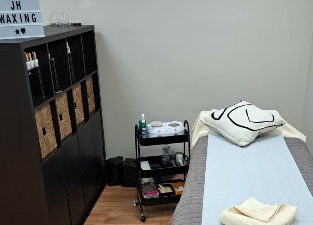 Tranquil waxing room at JH Specialised Waxing, Carrickmines, County Dublin, IE with a cozy bed and modern decor.