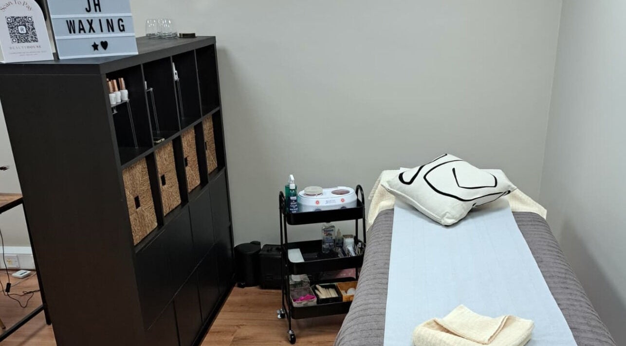 Tranquil waxing room at JH Specialised Waxing, Carrickmines, County Dublin, IE with a cozy bed and modern decor.