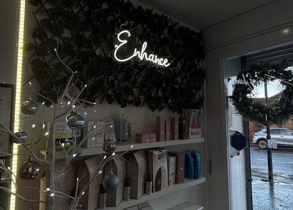 Enhance Hair & Beauty entrance in Clarkston, Scotland, GB with festive decor and glowing sign.