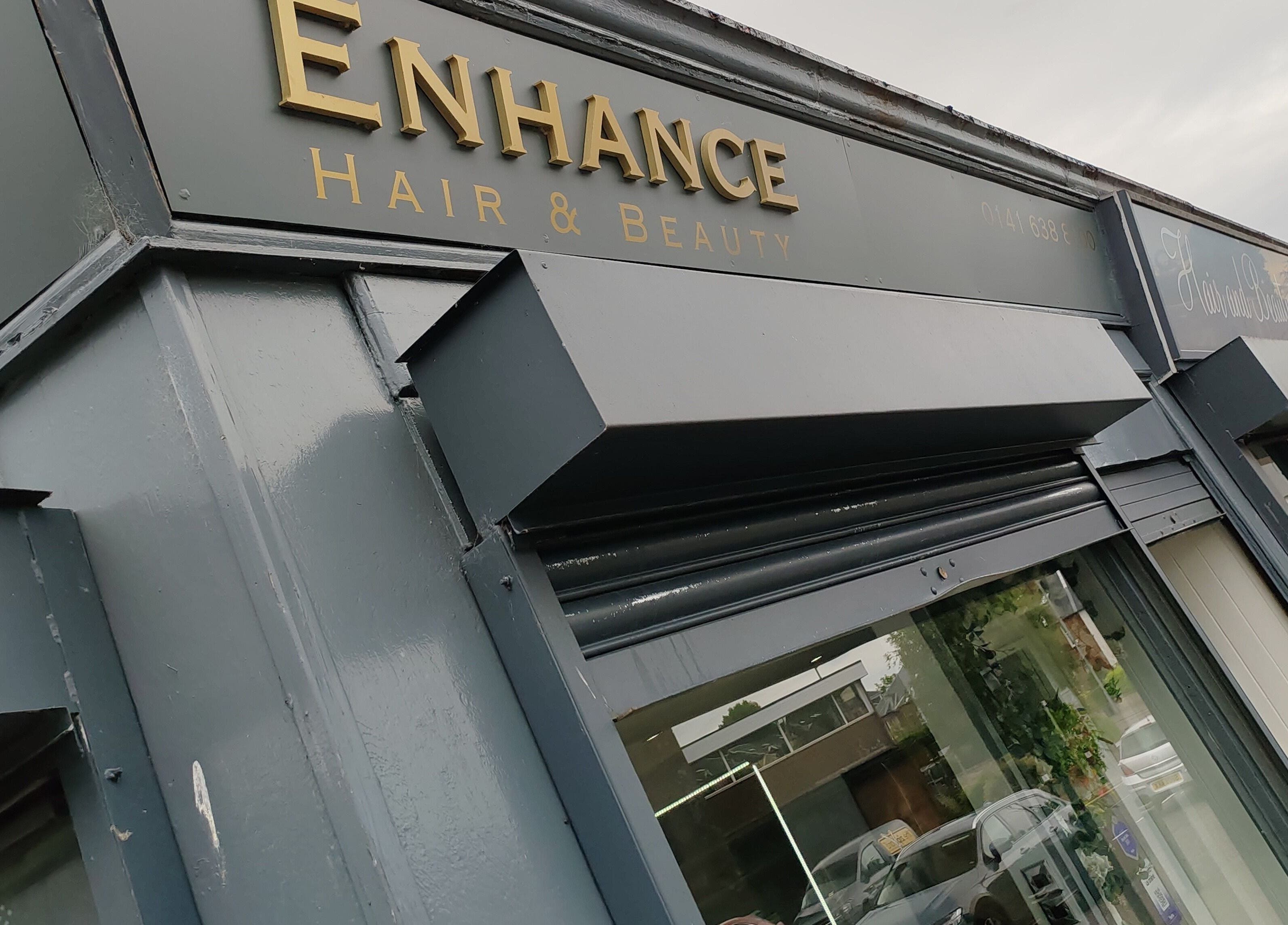 Exterior view of Enhance Hair & Beauty in Clarkston, Scotland, GB showcasing the elegant storefront sign.