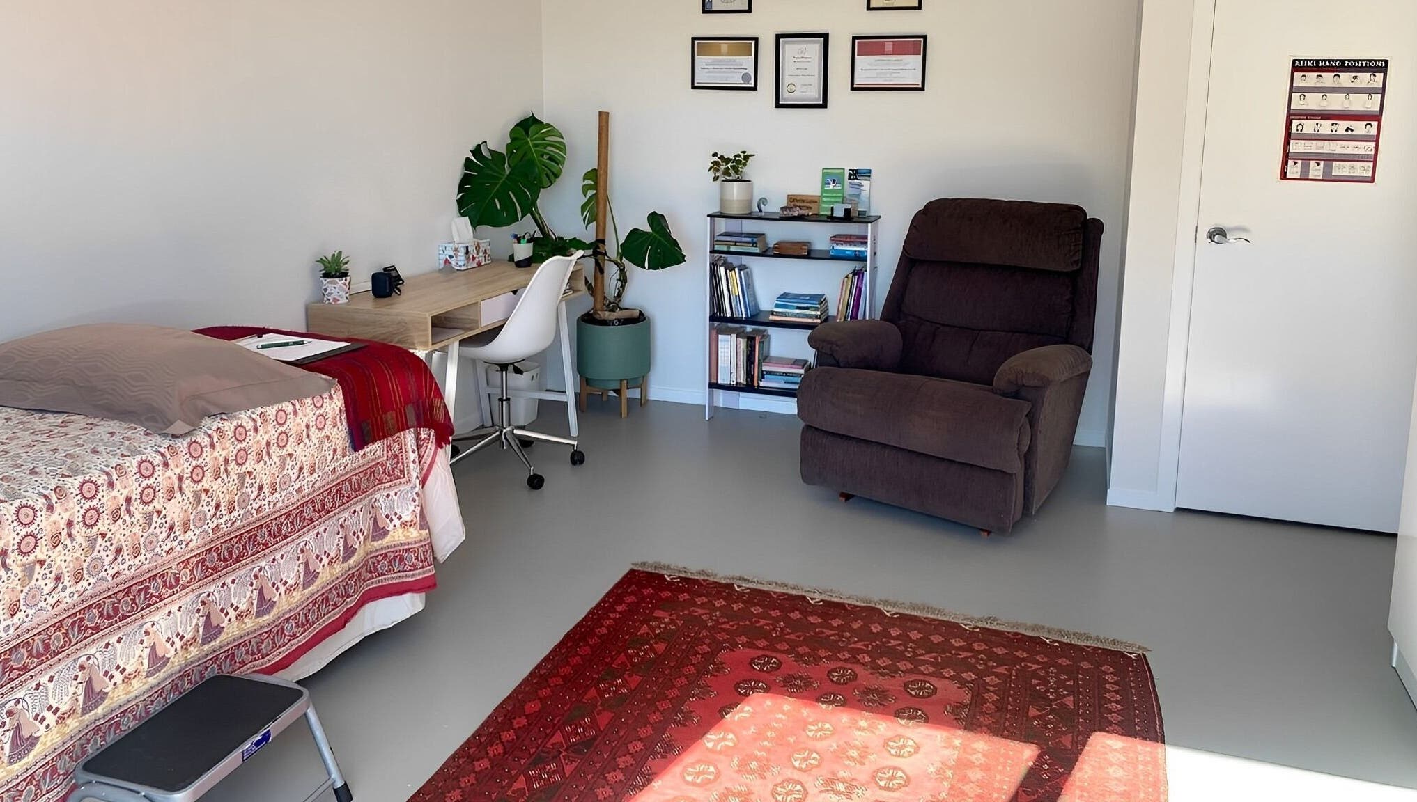 Cozy therapy room at Catherine Lupton Therapies in Tapapa, Waikato, NZ, featuring a massage table and recliner.