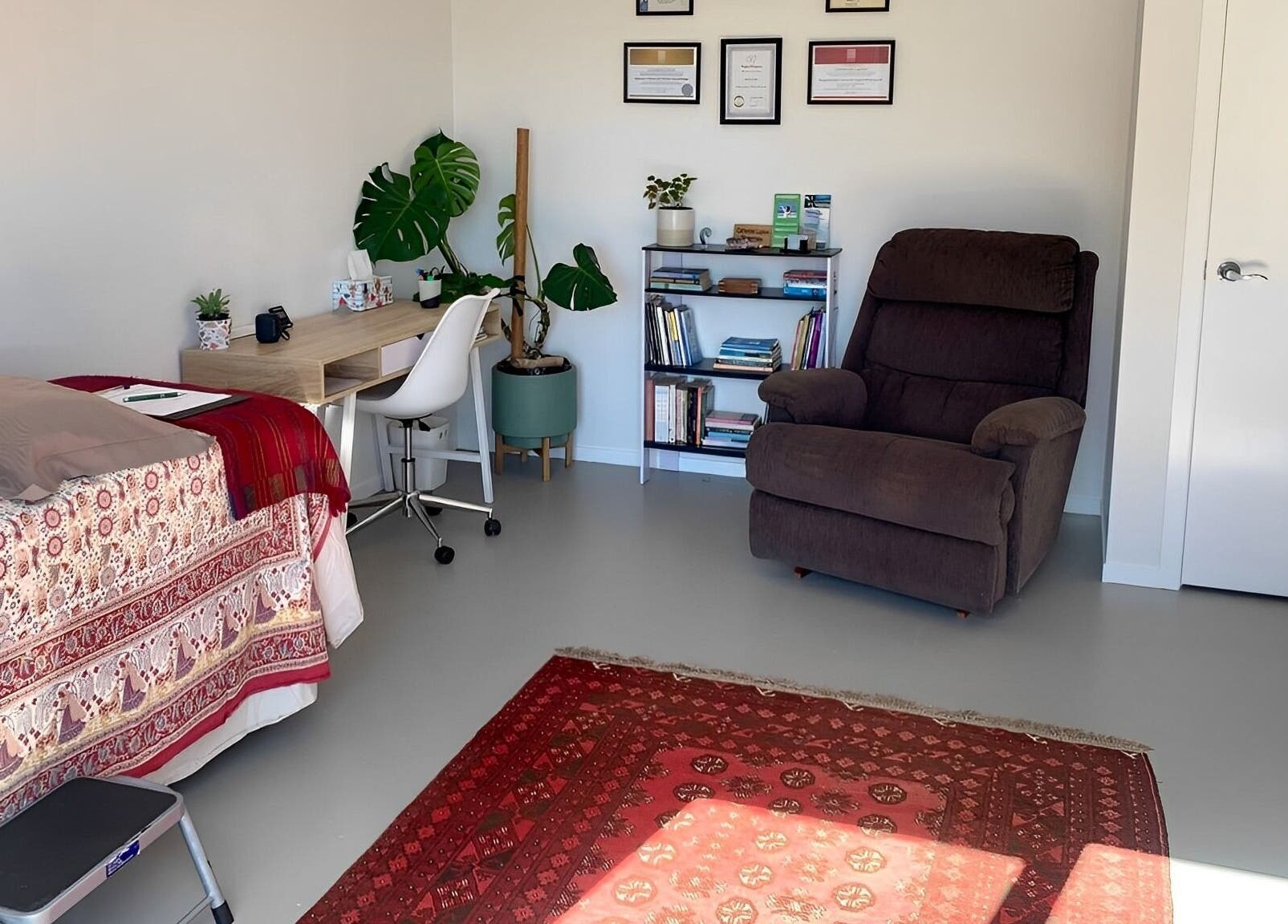 Cozy therapy room at Catherine Lupton Therapies in Tapapa, Waikato, NZ, featuring a massage table and recliner.