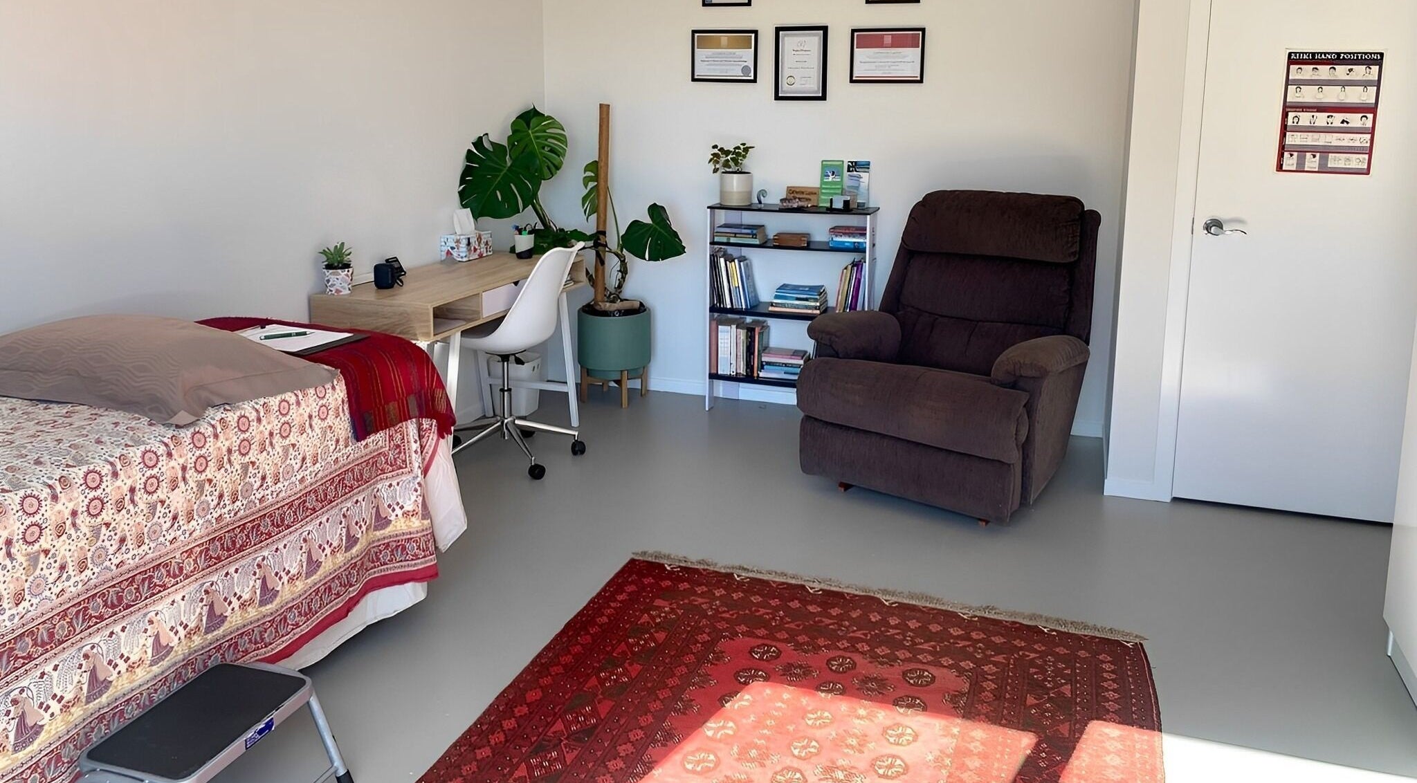 Cozy therapy room at Catherine Lupton Therapies in Tapapa, Waikato, NZ, featuring a massage table and recliner.