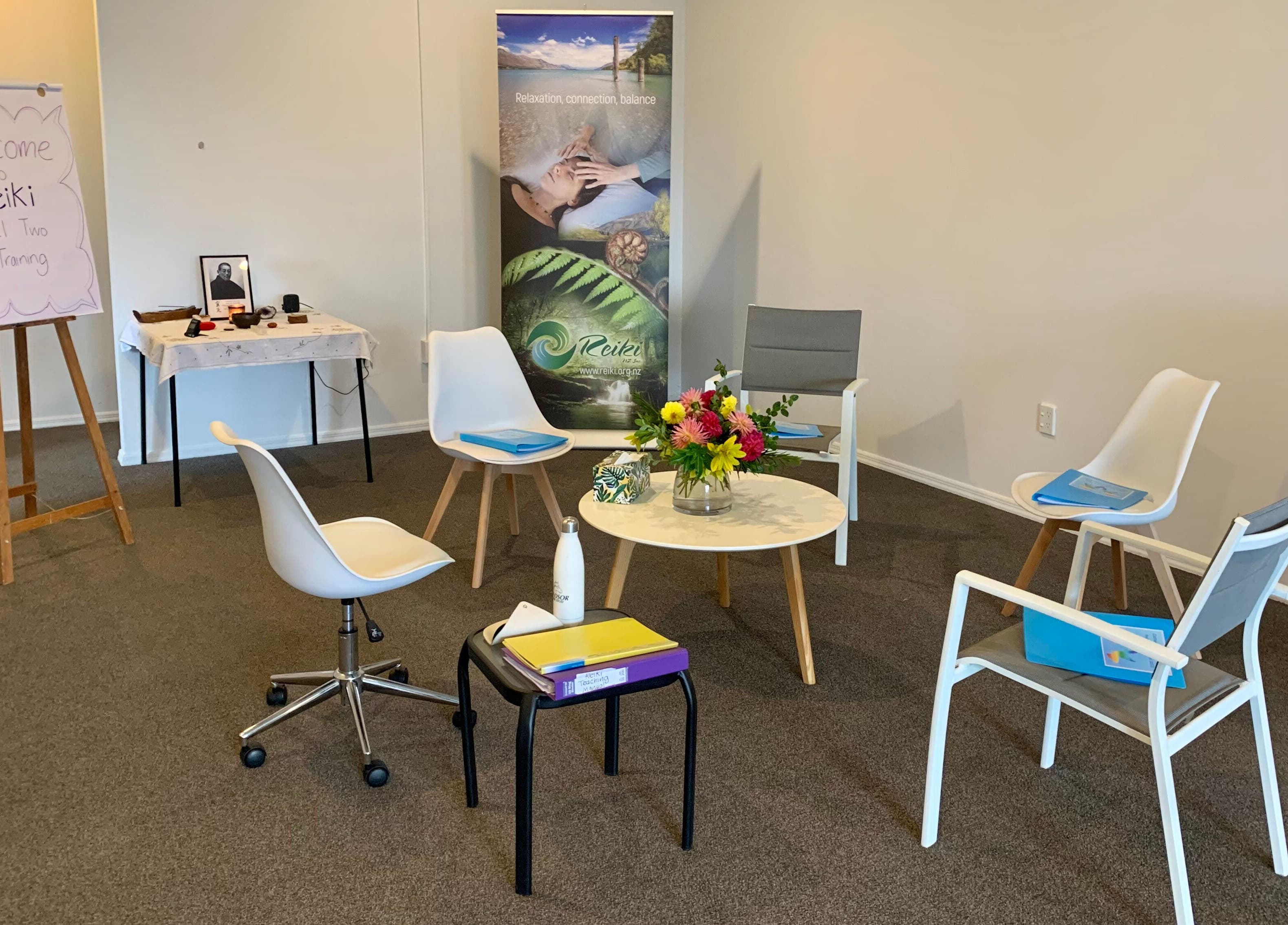 Reiki training room setup at Catherine Lupton Therapies, Tapapa, Waikato, NZ with chairs and flowers.