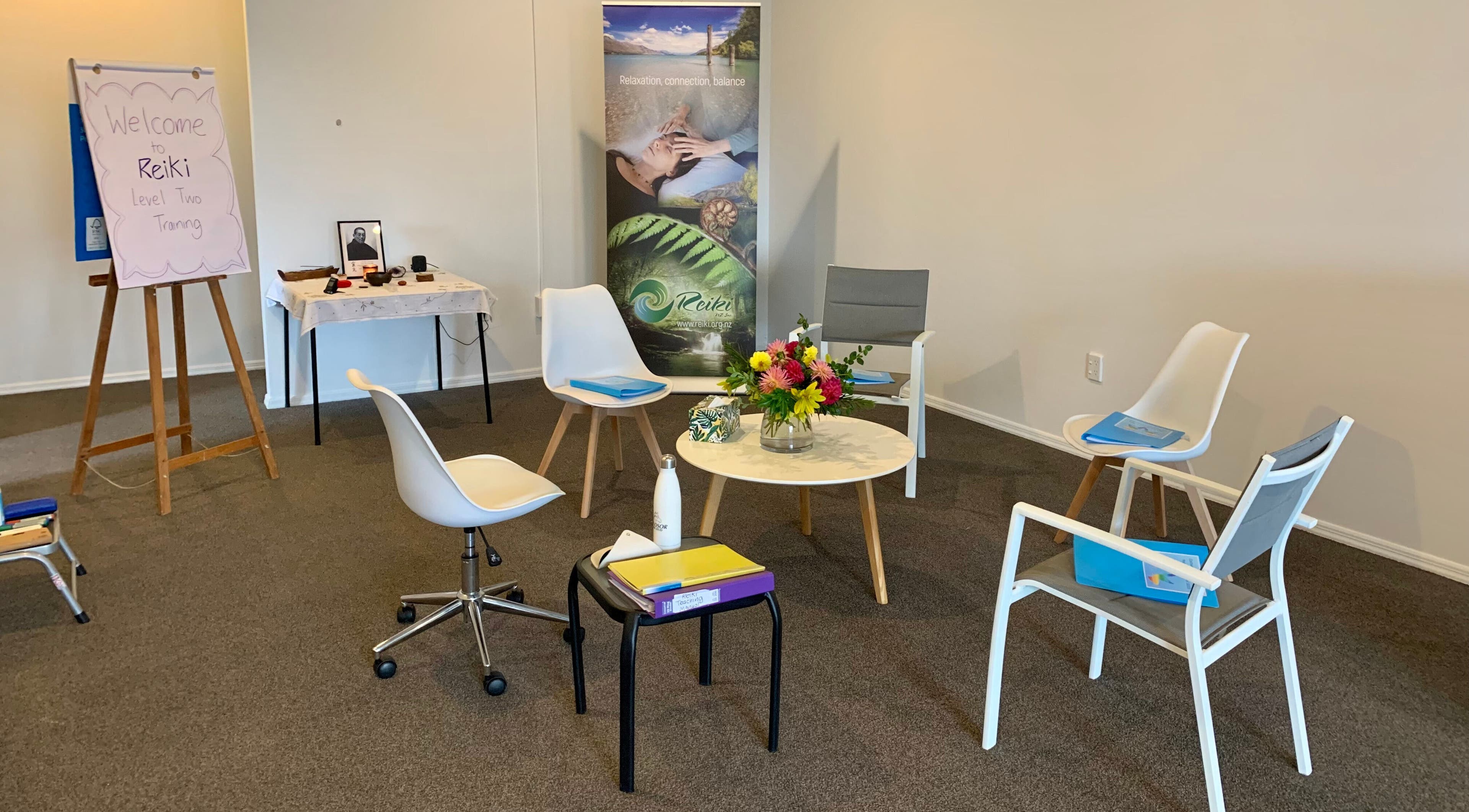 Reiki training room setup at Catherine Lupton Therapies, Tapapa, Waikato, NZ with chairs and flowers.