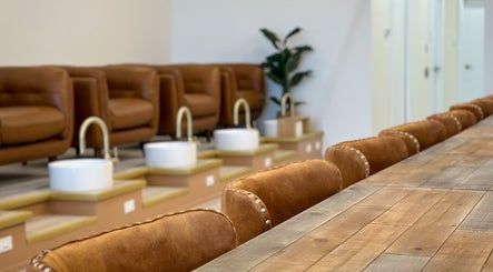 Elegant seating at Sweetling Nails and Spa, Ottawa, Ontario, CA, featuring plush chairs and sleek pedicure stations.