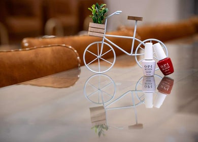Stylish nail polish setup at Sweetling Nails and Spa, Ottawa, Ontario, CA, featuring decorative bicycle.