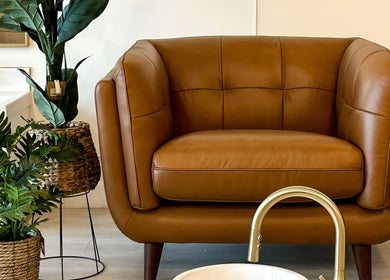 Elegant brown chair with plants at Sweetling Nails and Spa, Ottawa, Ontario, CA enhancing relaxation ambiance.