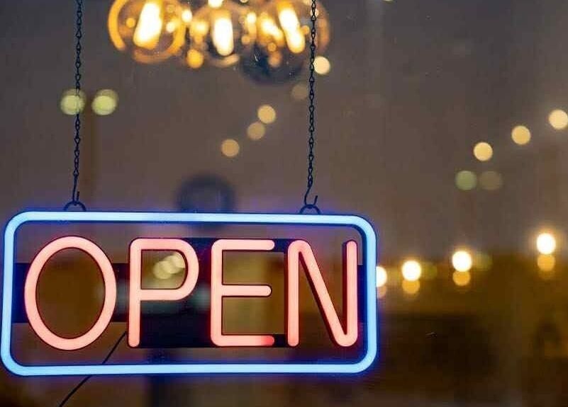 Bright neon 'Open' sign at Sweetling Nails and Spa, Ottawa, Ontario, CA inviting visitors in.