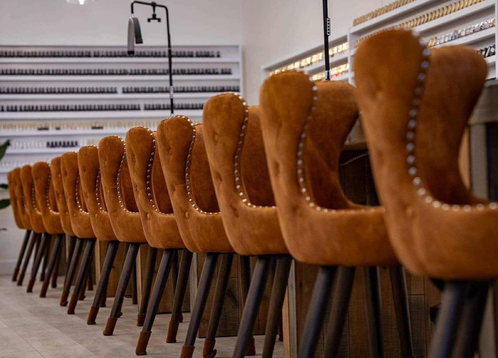 Elegant nail salon with velvet chairs and polish display at Sweetling Nails and Spa, Ottawa, Ontario, CA.