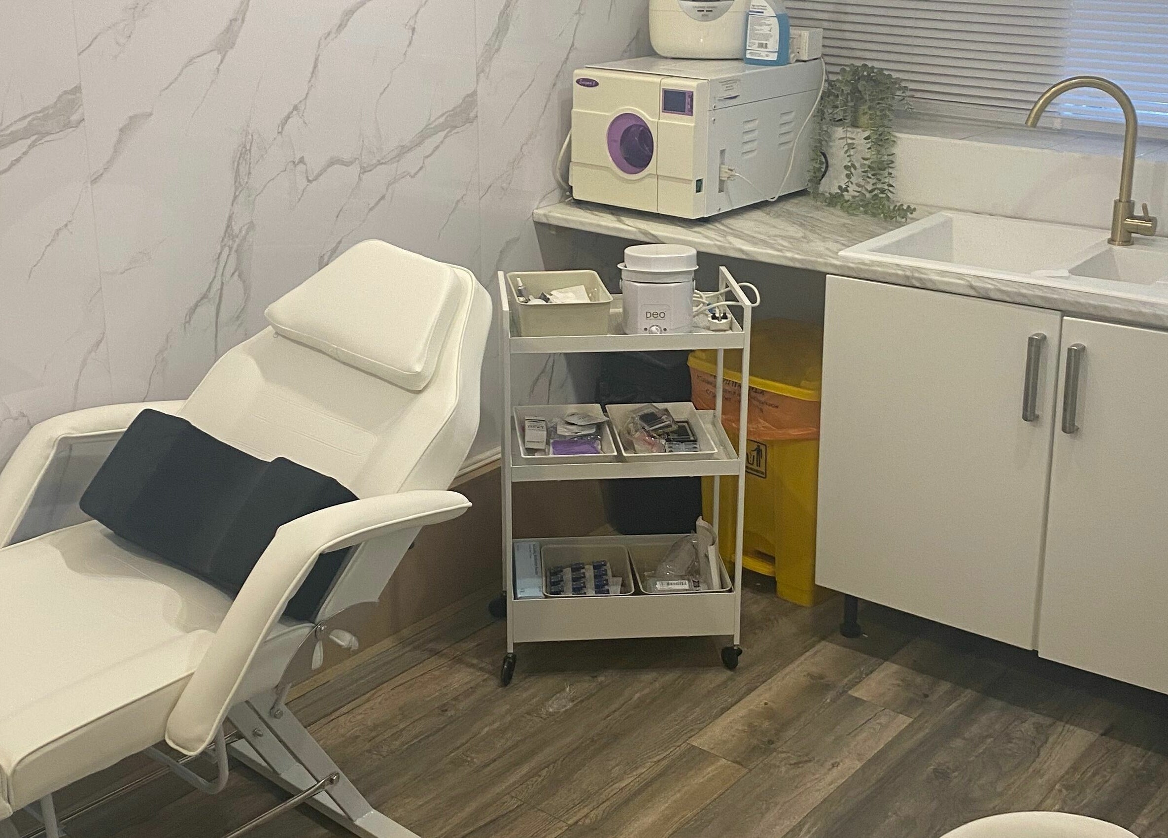 Modern spa room at Dy9 Design, Stourbridge, England, GB with white recliner, marble counter, and treatment tools.