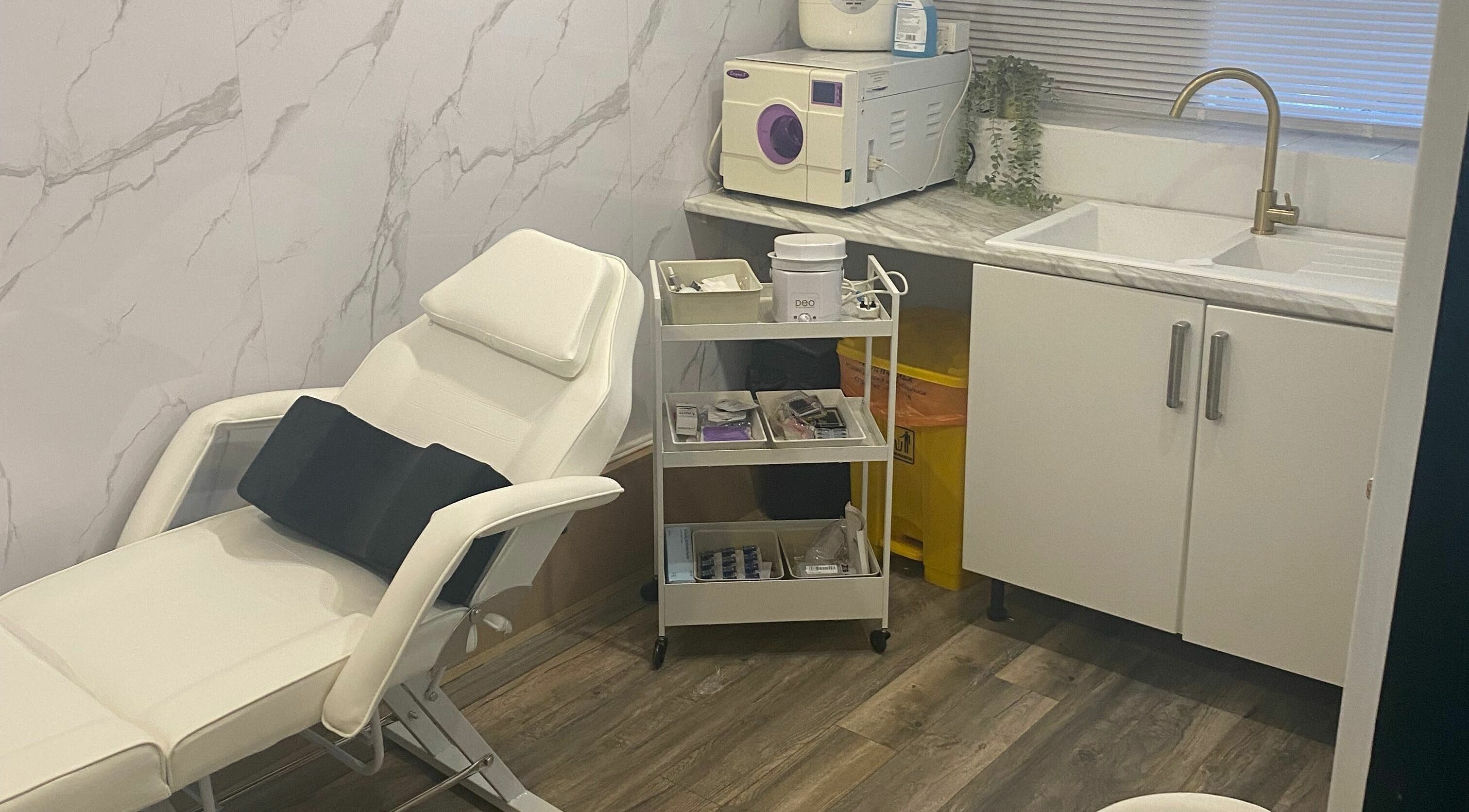 Modern spa room at Dy9 Design, Stourbridge, England, GB with white recliner, marble counter, and treatment tools.