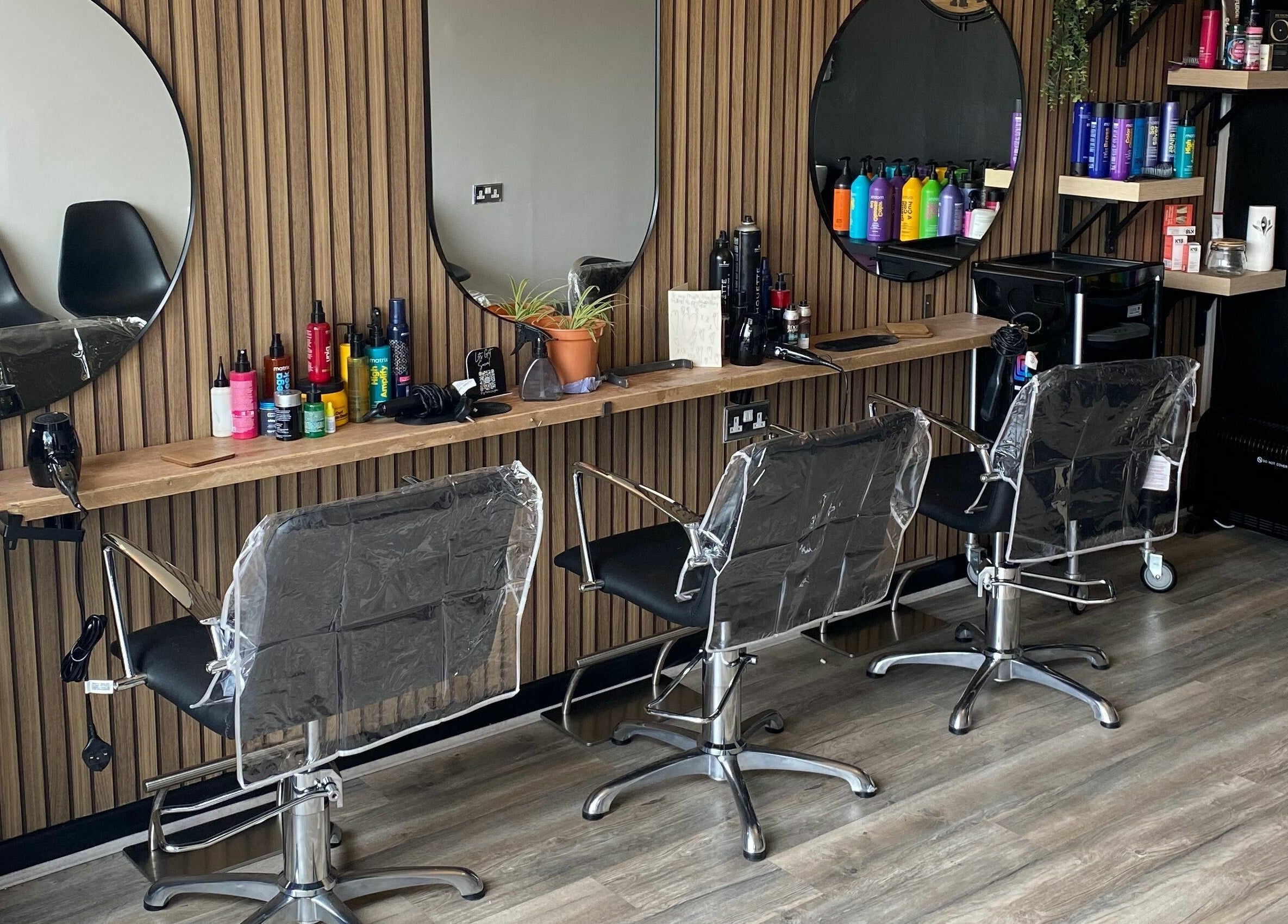 Modern beauty salon at Dy9 Design, Stourbridge, England, GB with stylish chairs and mirrors.