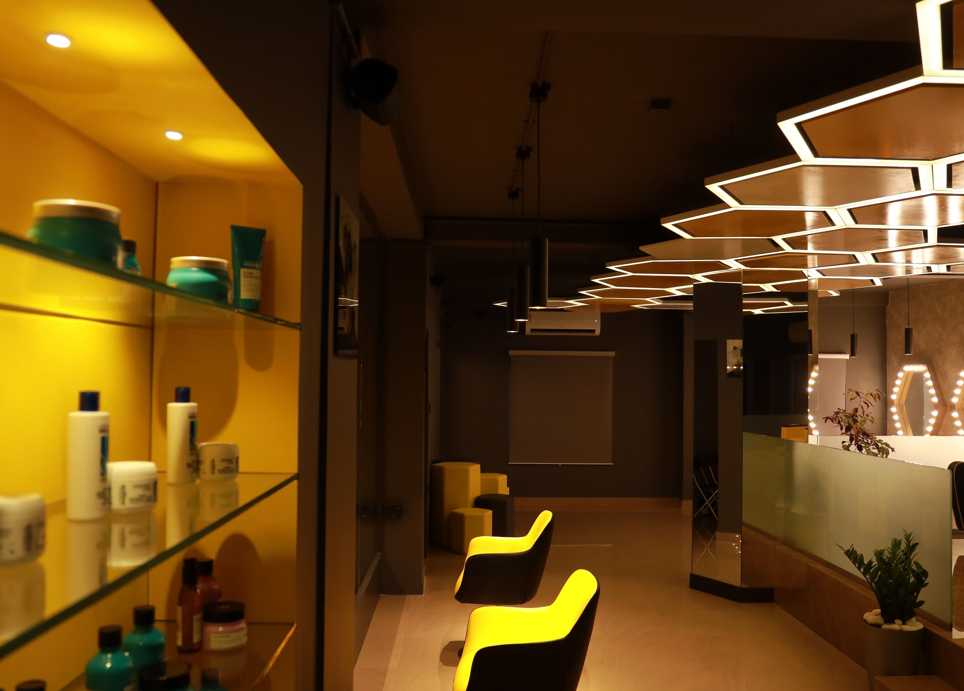 Modern interior of One Touch Fit & Glam in Thiruvananthapuram, Kerala, IN, featuring stylish lighting and seating.