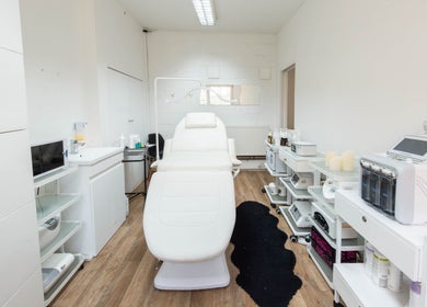 Modern treatment room at Ana Clara Barreto Beauty, London, England, GB, featuring sleek white decor and advanced equipment.