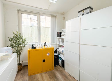 Modern therapy room at Ana Clara Barreto Beauty, London, England, GB, featuring sleek storage and natural light.