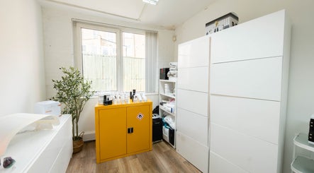 Modern therapy room at Ana Clara Barreto Beauty, London, England, GB, featuring sleek storage and natural light.