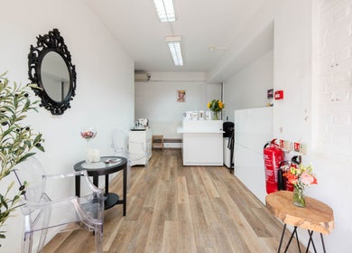 Modern reception area at Ana Clara Barreto Beauty in London, England, GB featuring elegant decor and seating.