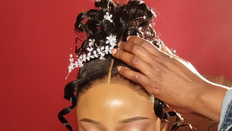 Intricate hair styling at TheTouch by leoRock in Johannesburg, Gauteng, ZA with delicate floral accessory.