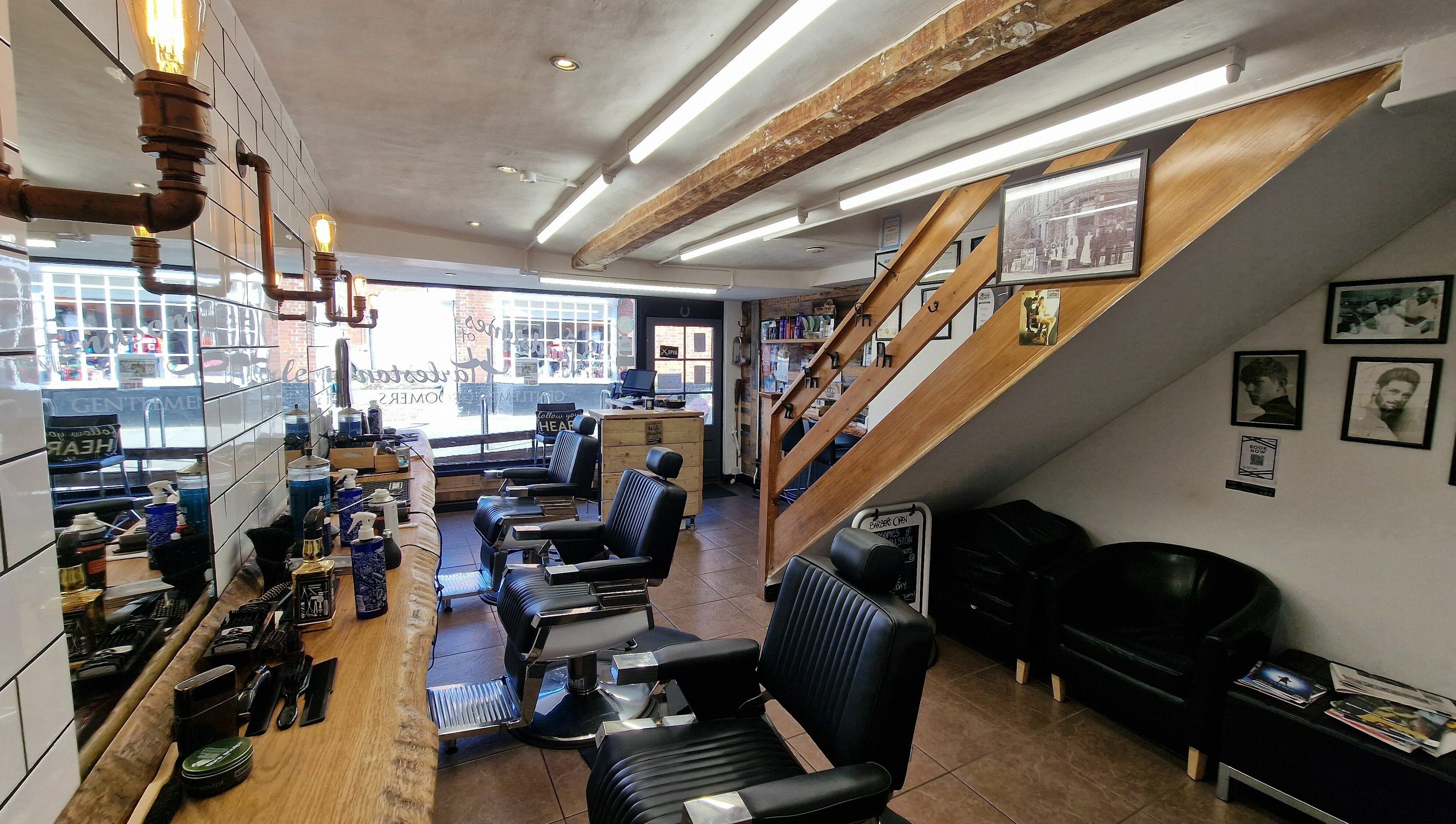 Interior of Handsomes of Harleston, a stylish barbershop in Harleston, England, GB, featuring modern chairs.