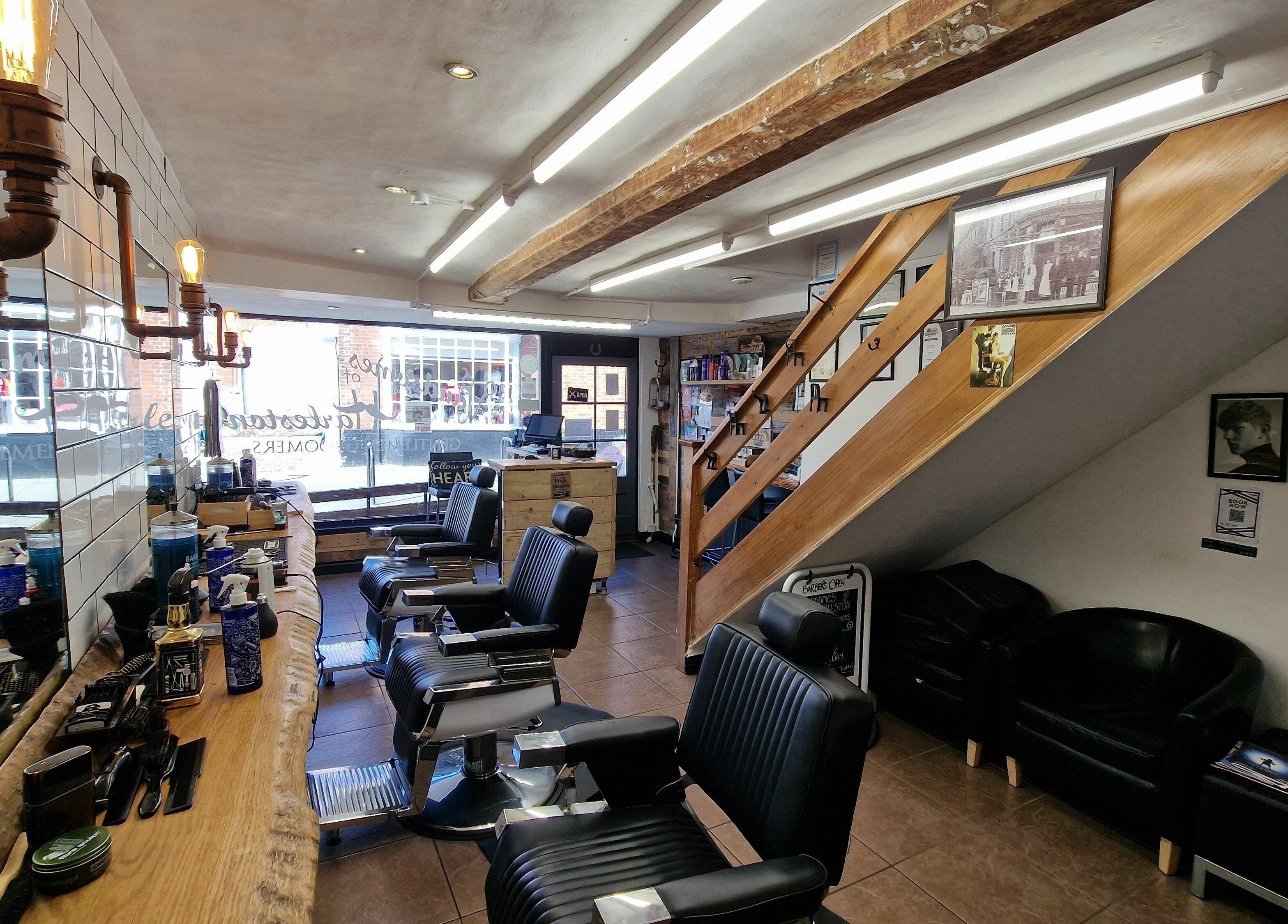 Interior of Handsomes of Harleston, a stylish barbershop in Harleston, England, GB, featuring modern chairs.