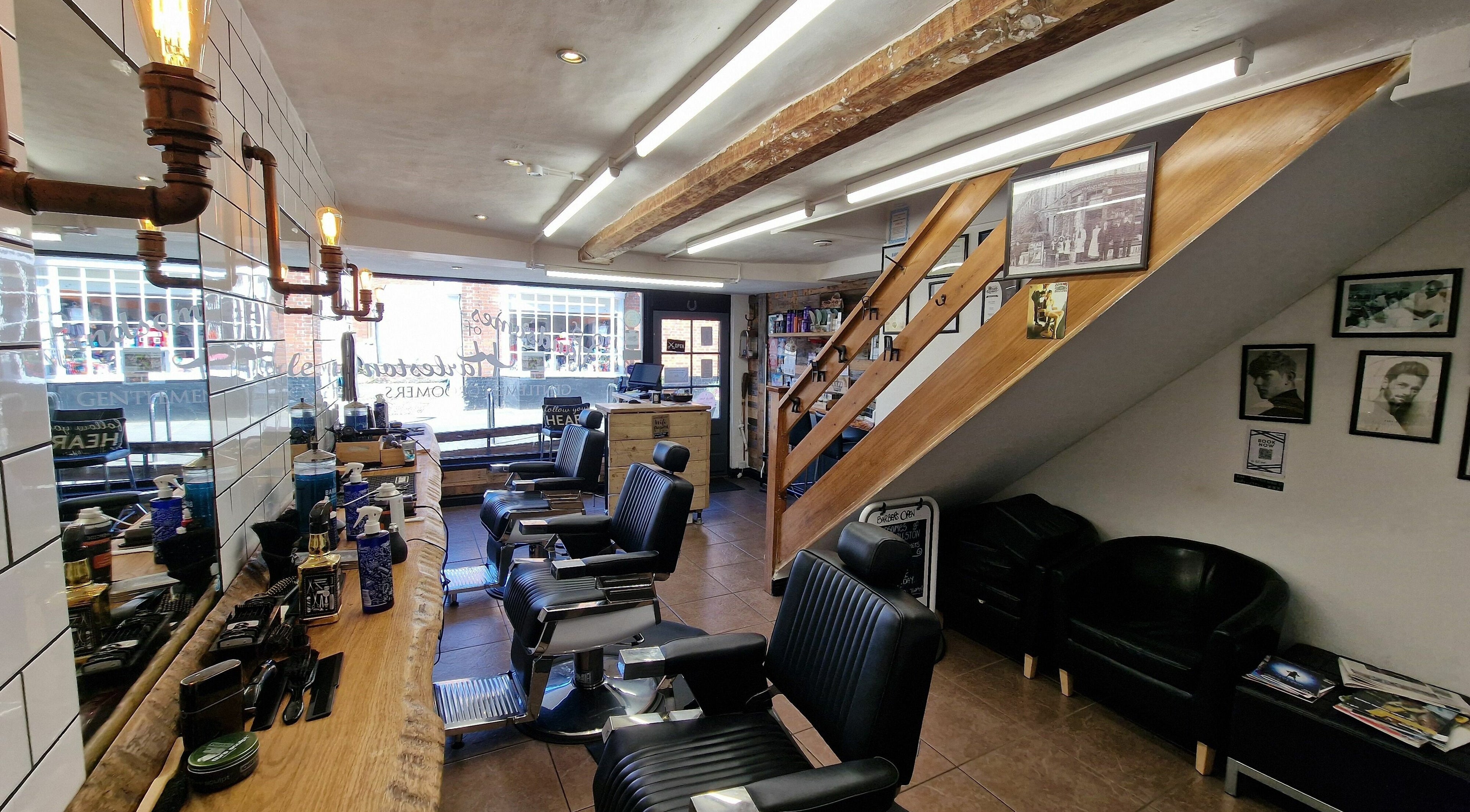 Interior of Handsomes of Harleston, a stylish barbershop in Harleston, England, GB, featuring modern chairs.