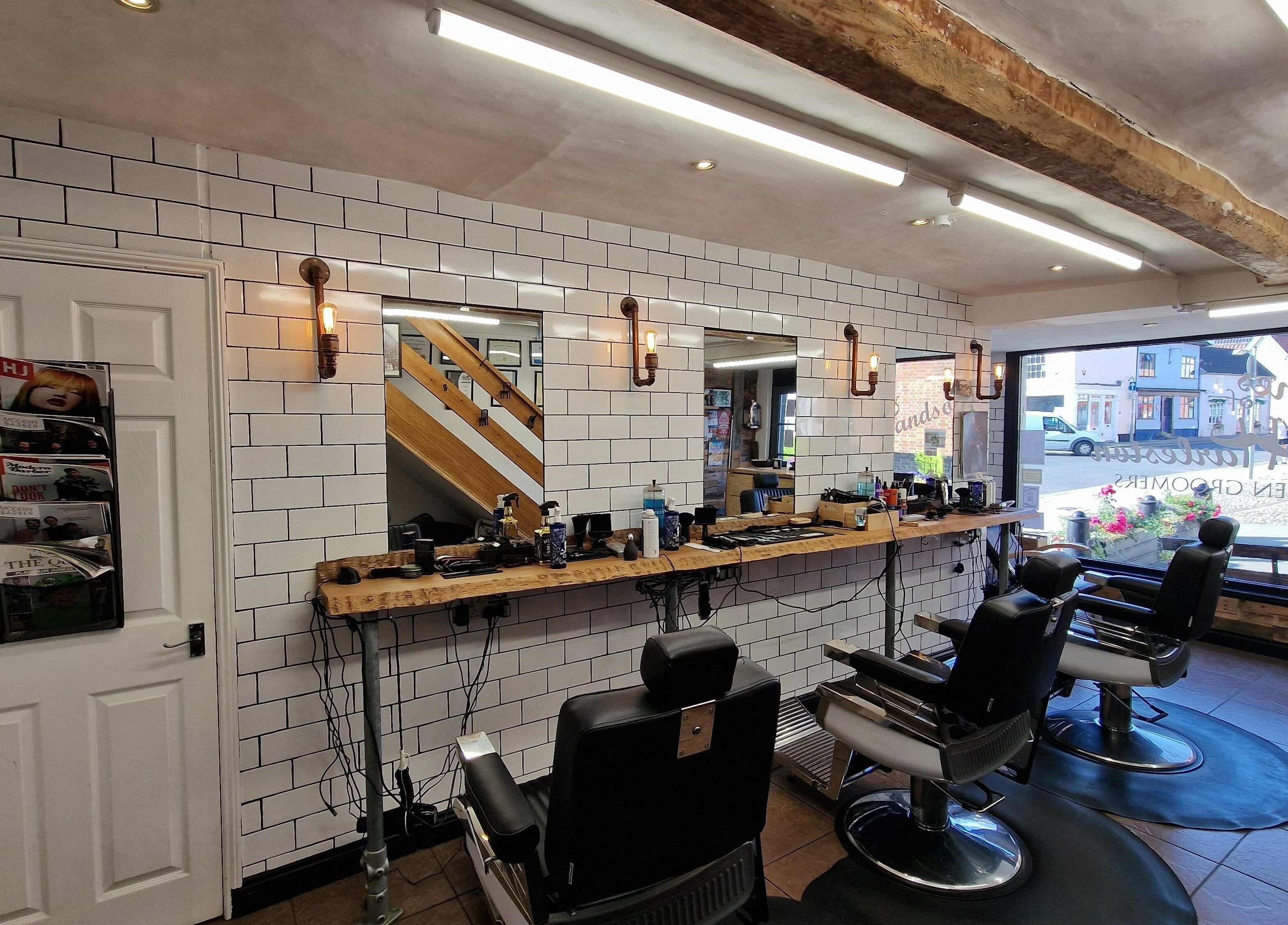Elegant interior of Handsomes of Harleston barber shop in Harleston, England, GB with stylish barber chairs.