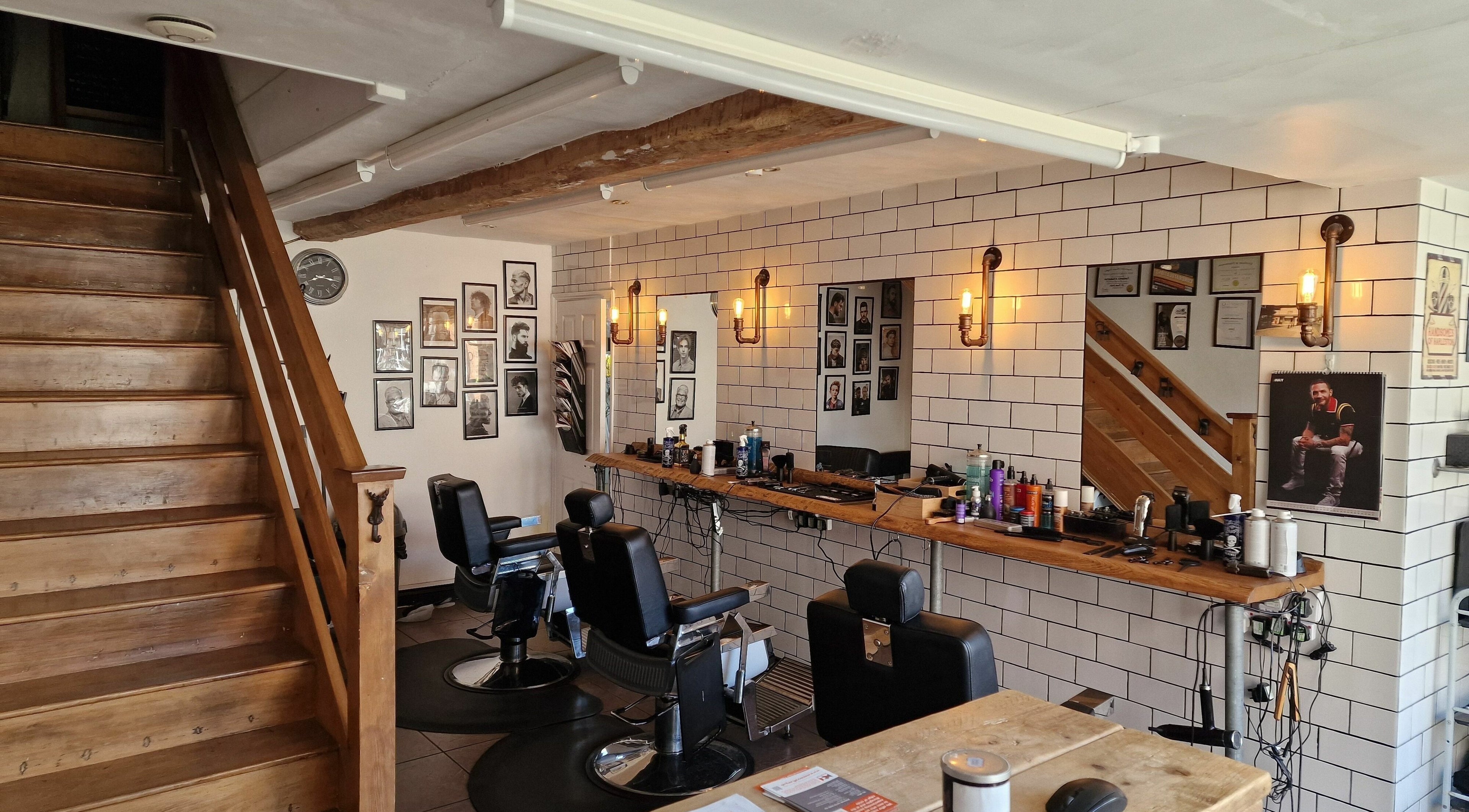 Elegant barber shop interior at Handsomes of Harleston in Harleston, England, GB with stylish decor and seating.