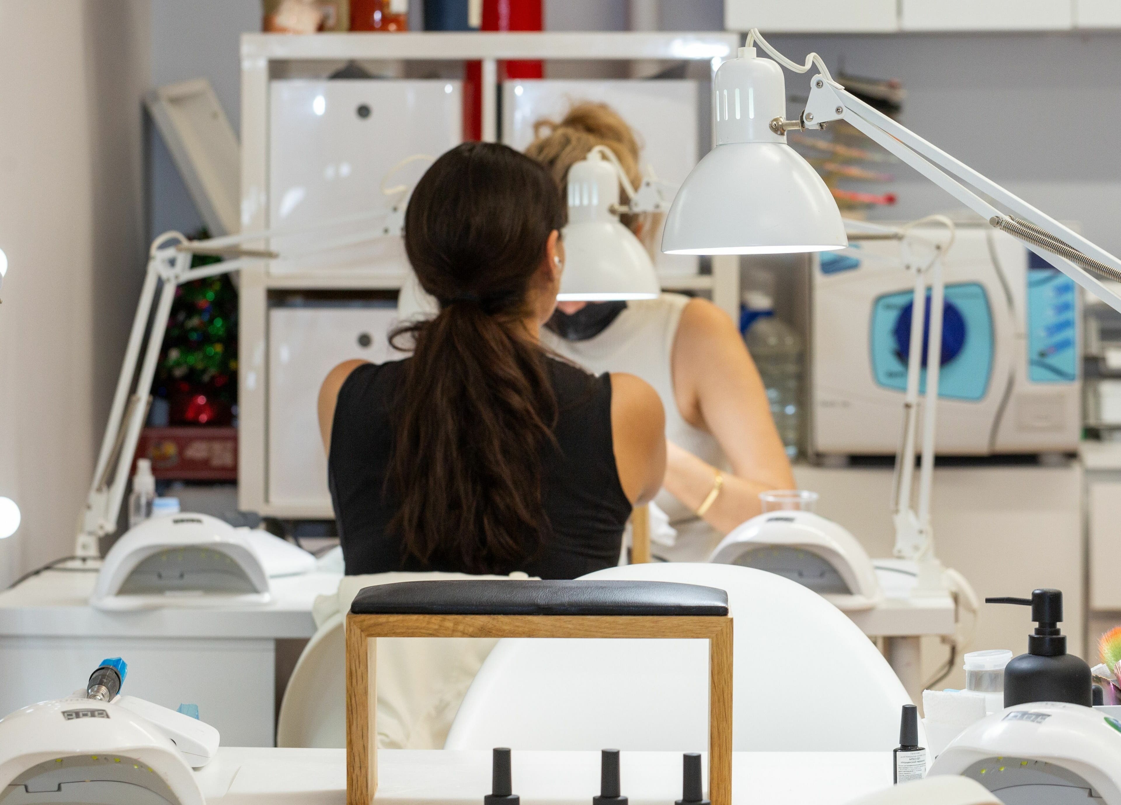 Client receiving manicure at Zaranailsnyc, New York, US. Nail salon setup with tools.