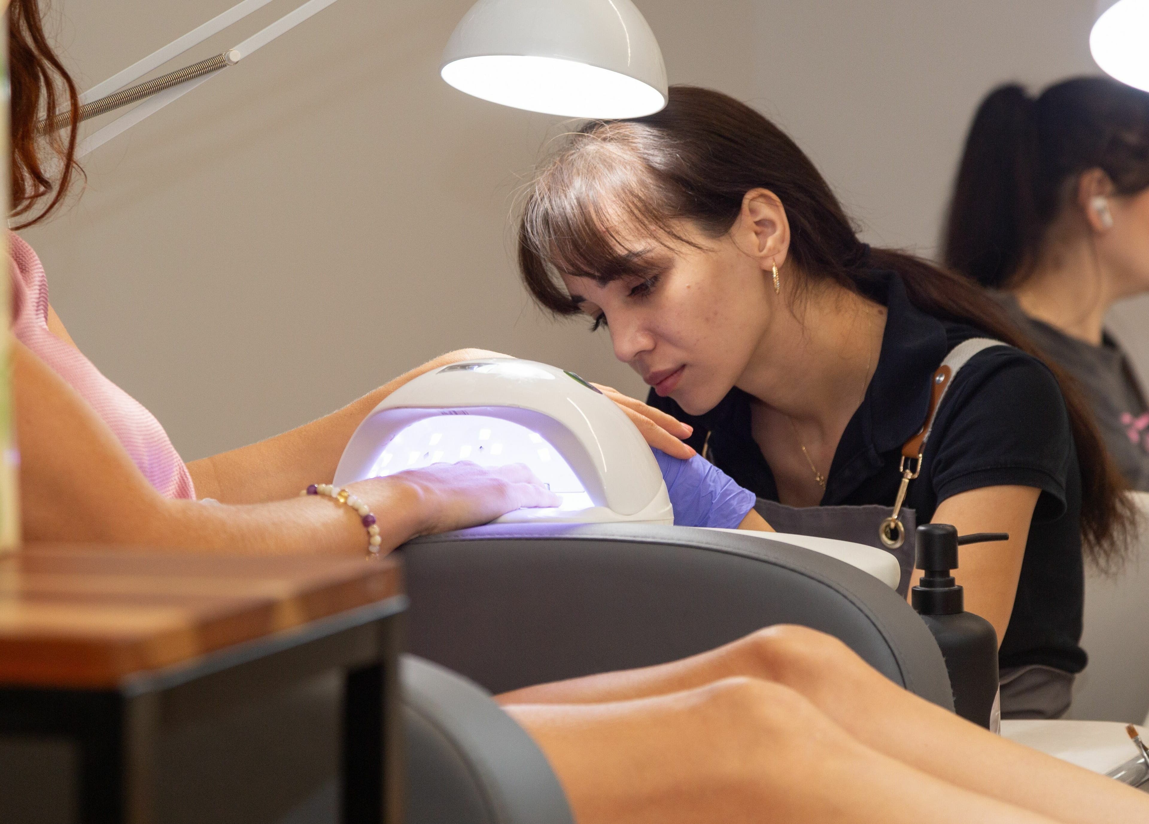 Nail technician at Zaranailsnyc, New York, US provides expert manicure.